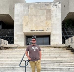 Daniel Ramos Matos poses on the steps of the Arquivo Nacional Torre do Tombo in Lisbon, Portugal