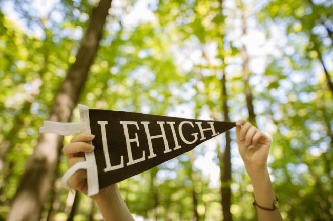 Lehigh Pennant held in front of campus
