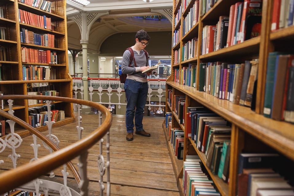 Student reading books in Linderman Library 